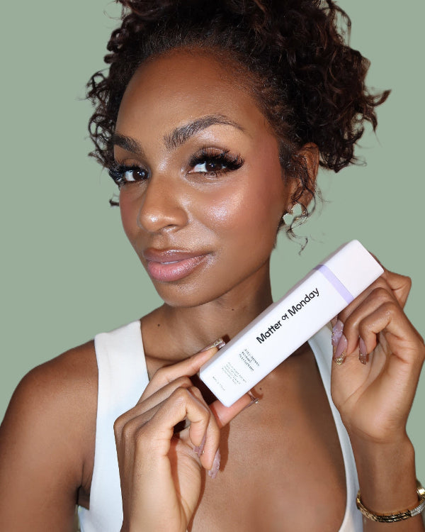 Woman holding a product with 'Mother Monday' branding against a green background