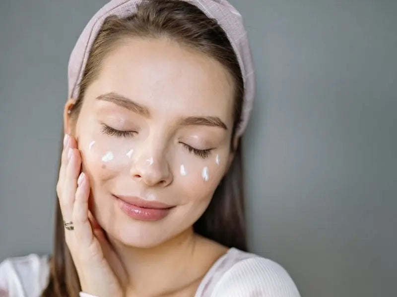 Cover image of a girl putting cream on her face