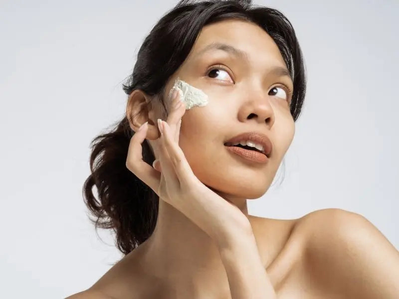 Cover image of a woman applying moisturiser on her face