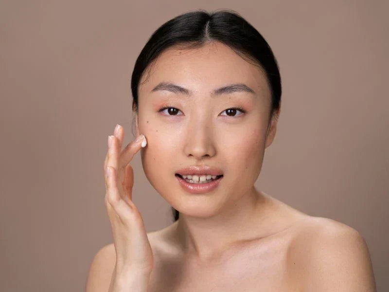 Woman using face cream