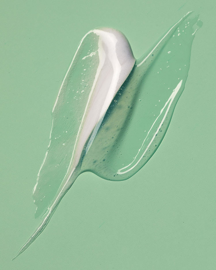 White cream or gel smear on a green background