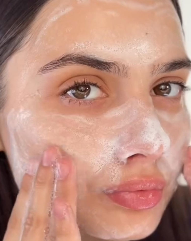 Person applying a facial mask with their fingers