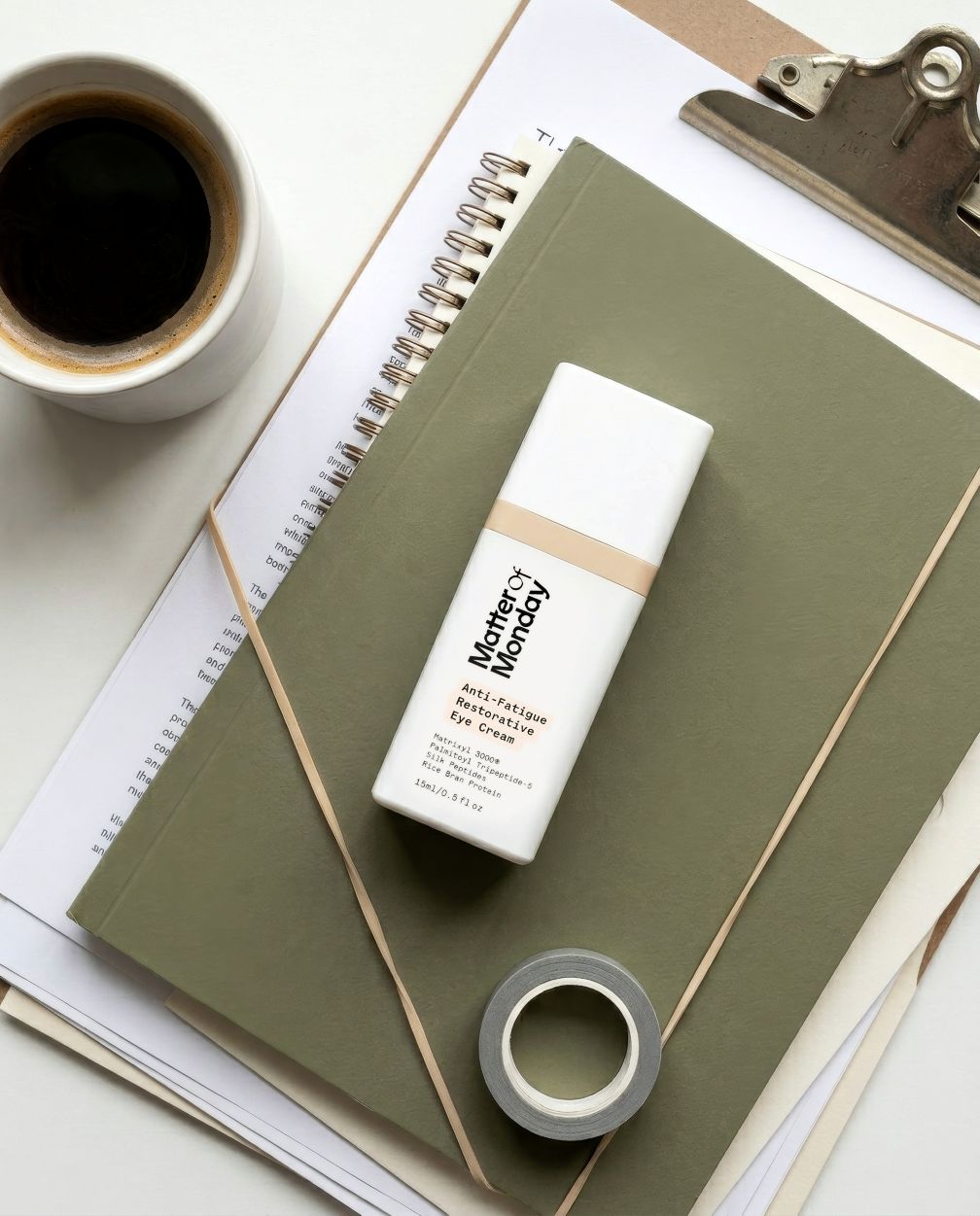 Eye cream on a notebook with a cup of coffee and a clipboard in the background